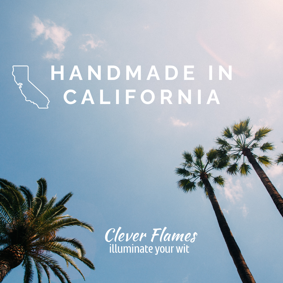 Two palm trees and a blue sky with clouds frame the text: “Handmade in California” next to the state outline, and “Clever Flames illuminate your wit,” describing Printify’s Scented Soy Candle—The Calming Scent of a Color Coded Spreadsheet.