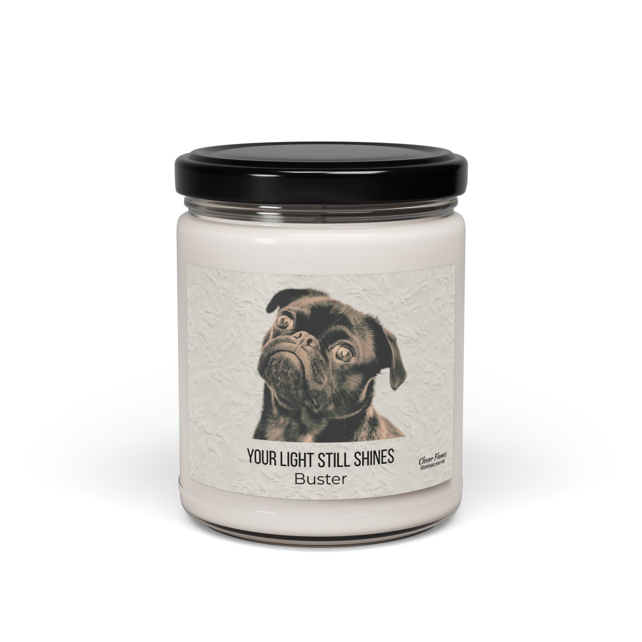 The Your Light Still Shines Personalized Pet Memorial Candle by Printify features a white jar with a black lid and a label with a black pug, the text “YOUR LIGHT STILL SHINES,” and pet’s name. A touching sympathy gift for pet lovers.