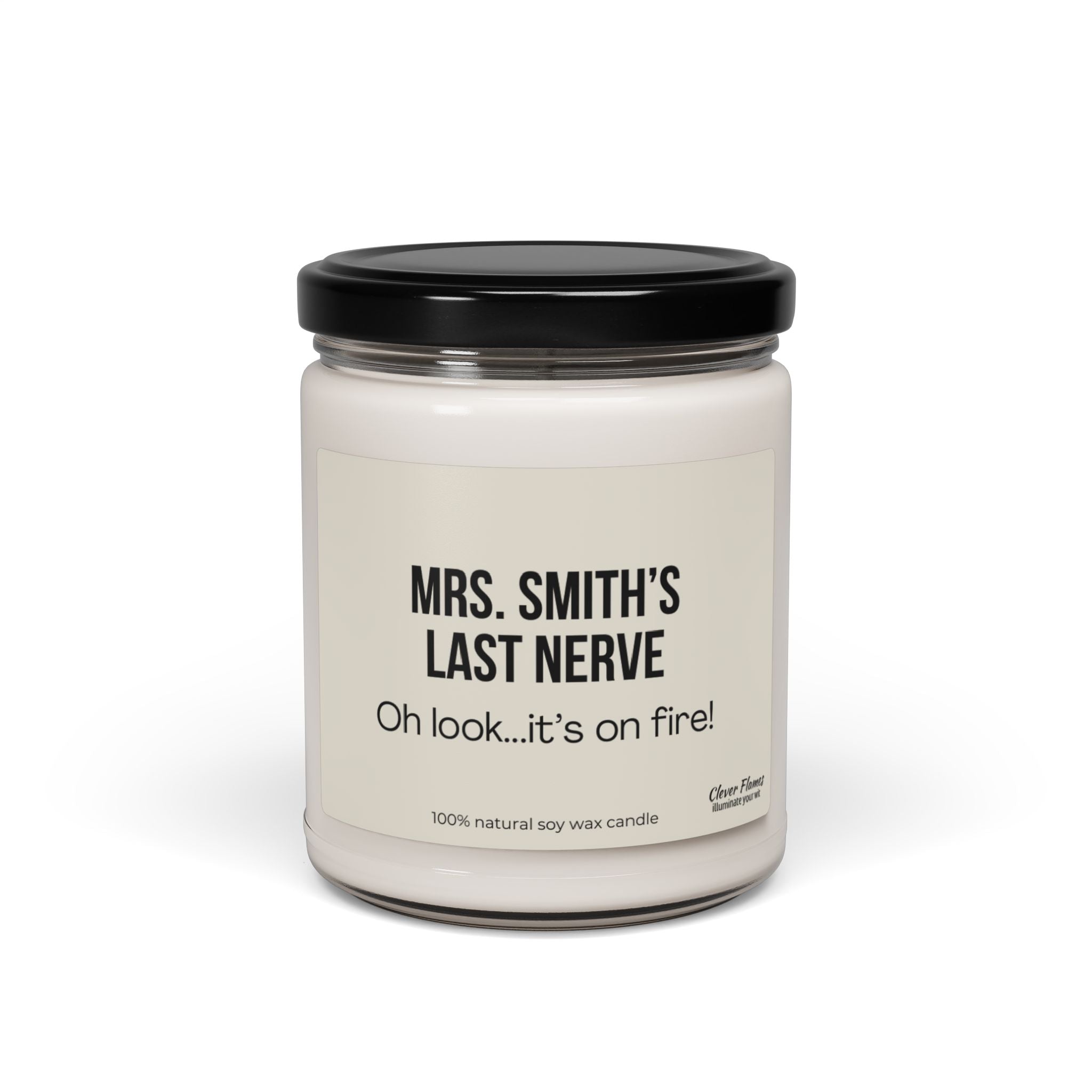 A white candle housed in a glass jar with a black lid. The label displays: "MRS. SMITH'S LAST NERVE" and "Oh look...it's on fire!" Crafted from 100% natural soy wax, this Printify candle is an ideal personalized teacher gift.