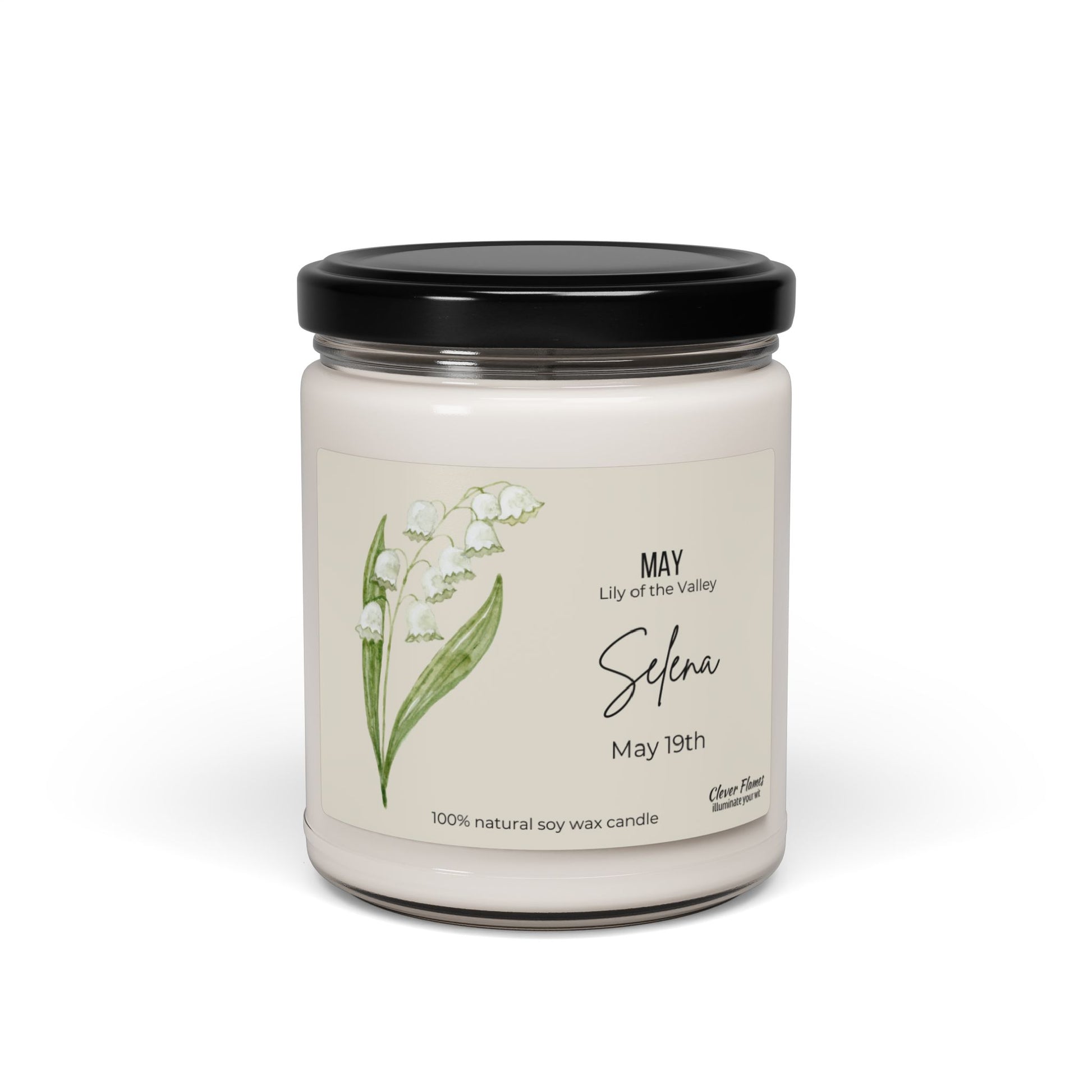 The Printify Personalized Birth Flower Candle features lilies of the valley on a white jar with a black lid, highlighting May, Lily of the Valley, Selena, and May 19th with 100% natural soy wax, celebrating Aprils birth flower.