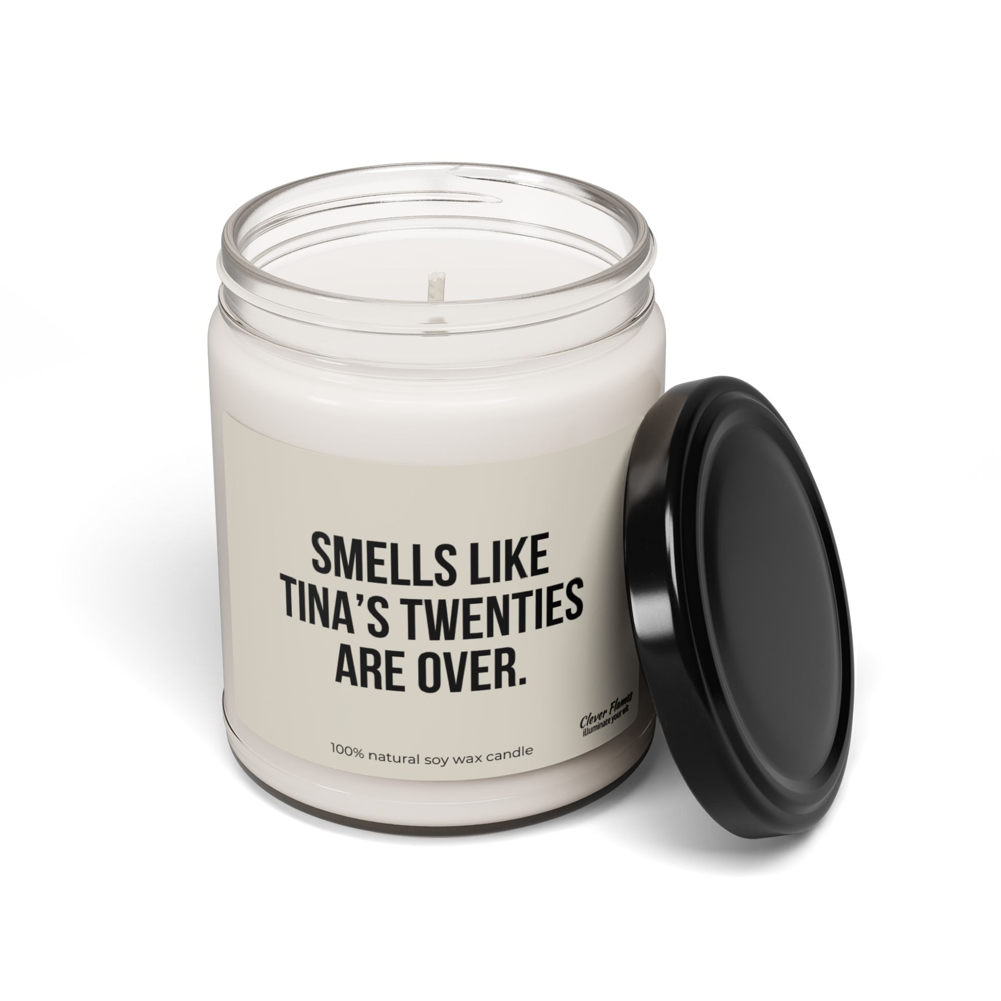 A personalized candle in a glass jar with a black lid by Printify. The label says, Smells Like Your Twenties Are Over, with text at the bottom indicating it's made from 100% natural soy wax—an ideal gift for a 30th birthday milestone. The lid is displayed next to the jar.