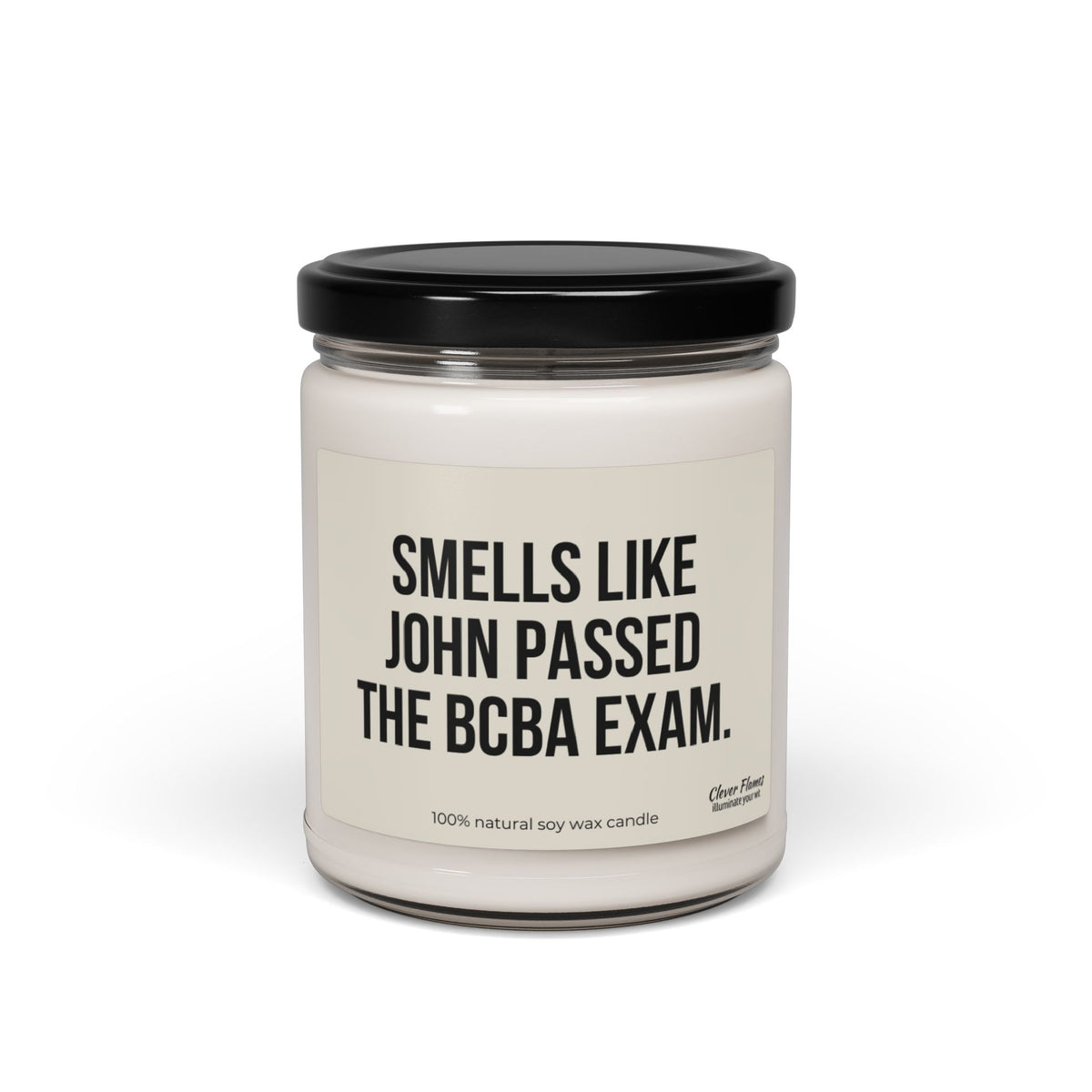 The Personalized Behavior Analyst Candle Gift by Printify features a white candle housed in a glass jar with a black lid and a striking label that reads, "Smells like John passed the BCBA exam." Made from a 100% natural soy wax blend, this minimalist design makes an ideal custom candle gift.