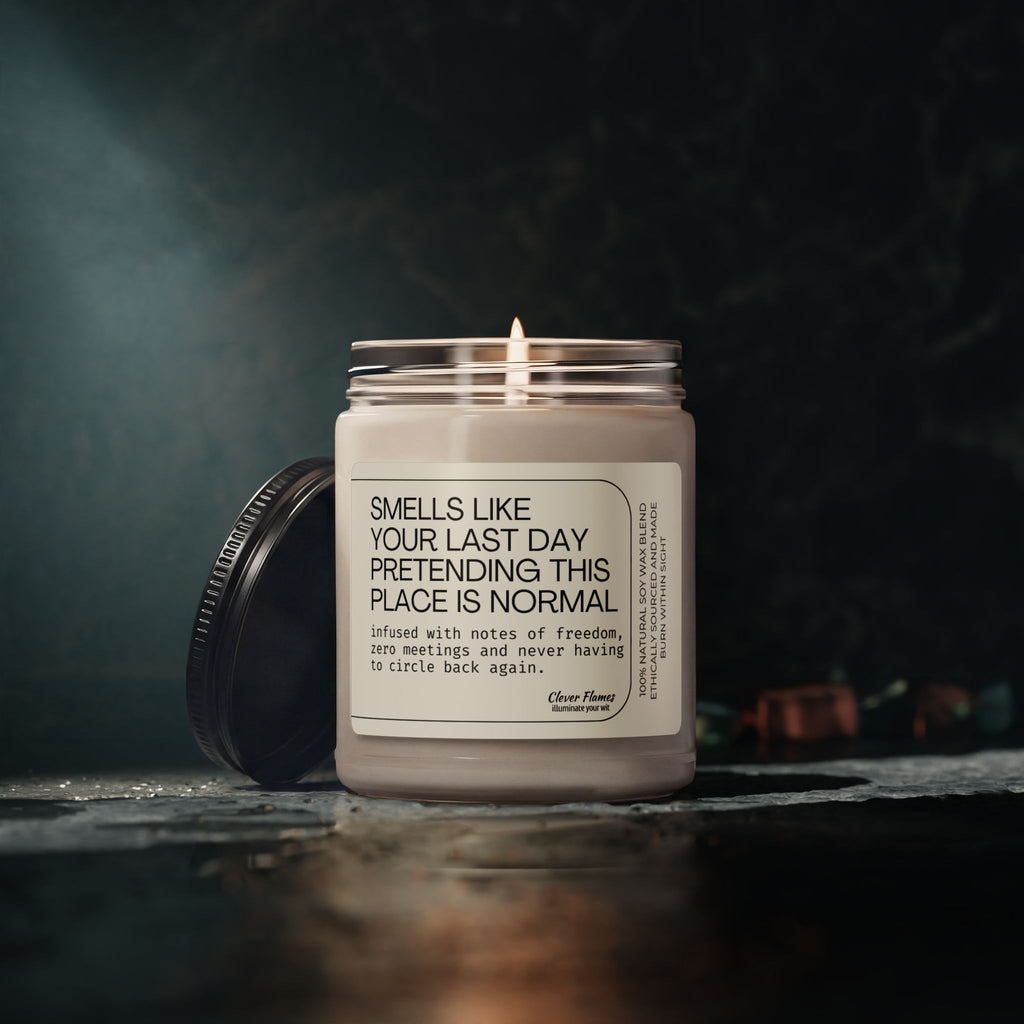 A lit white “Coworker Leaving Gift, Funny Office Farewell Candle, Going Away Gift for Coworker, Boss Leaving Gift, Retirement Candle” by Printify sits in a jar with its humorous label about quitting work visible. It rests on a dark surface with the lid propped against it; the dimly lit, slightly blurred background adds to the atmosphere—making it perfect for a funny office farewell or coworker leaving gift.