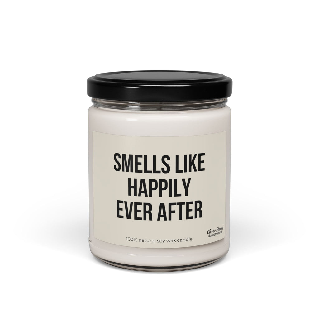 A white, scented candle made from 100% natural soy wax comes in a glass jar with a black lid, labeled "Smells Like Happily Ever After." This elegant Wedding candle is the perfect choice for an exquisite wedding favor or a delightful bridal shower gift.