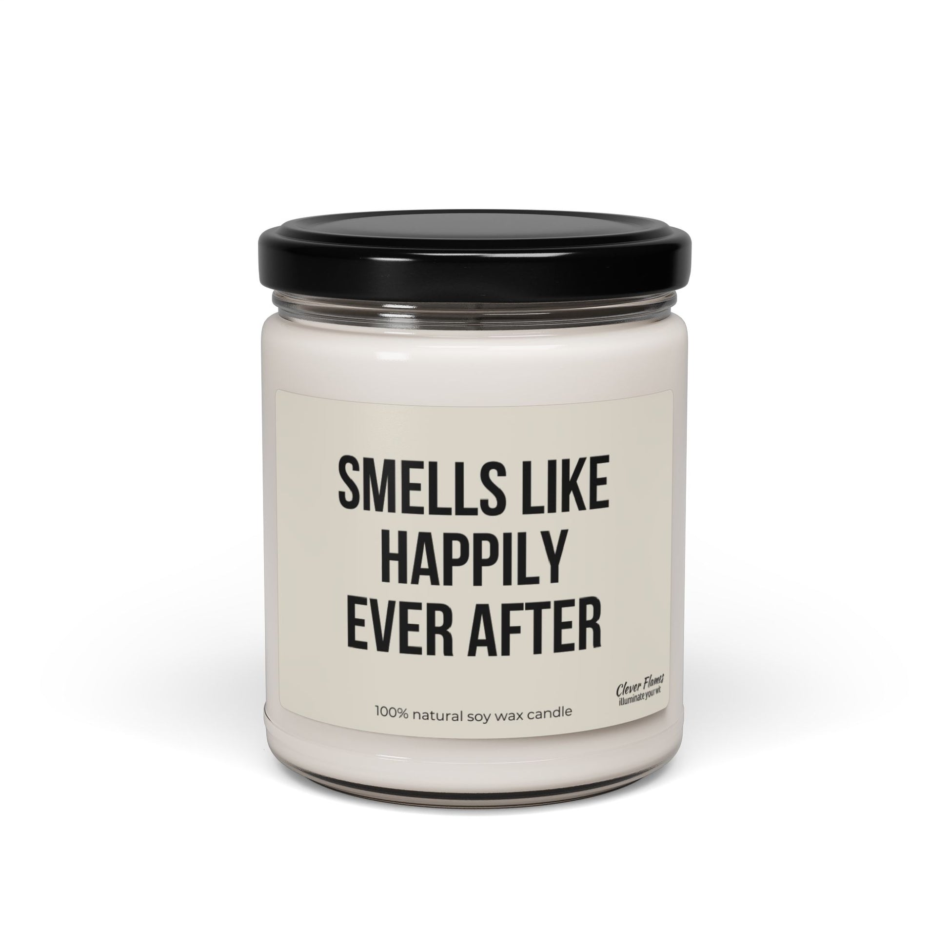 A white, scented candle made from 100% natural soy wax comes in a glass jar with a black lid, labeled "Smells Like Happily Ever After." This elegant Wedding candle is the perfect choice for an exquisite wedding favor or a delightful bridal shower gift.
