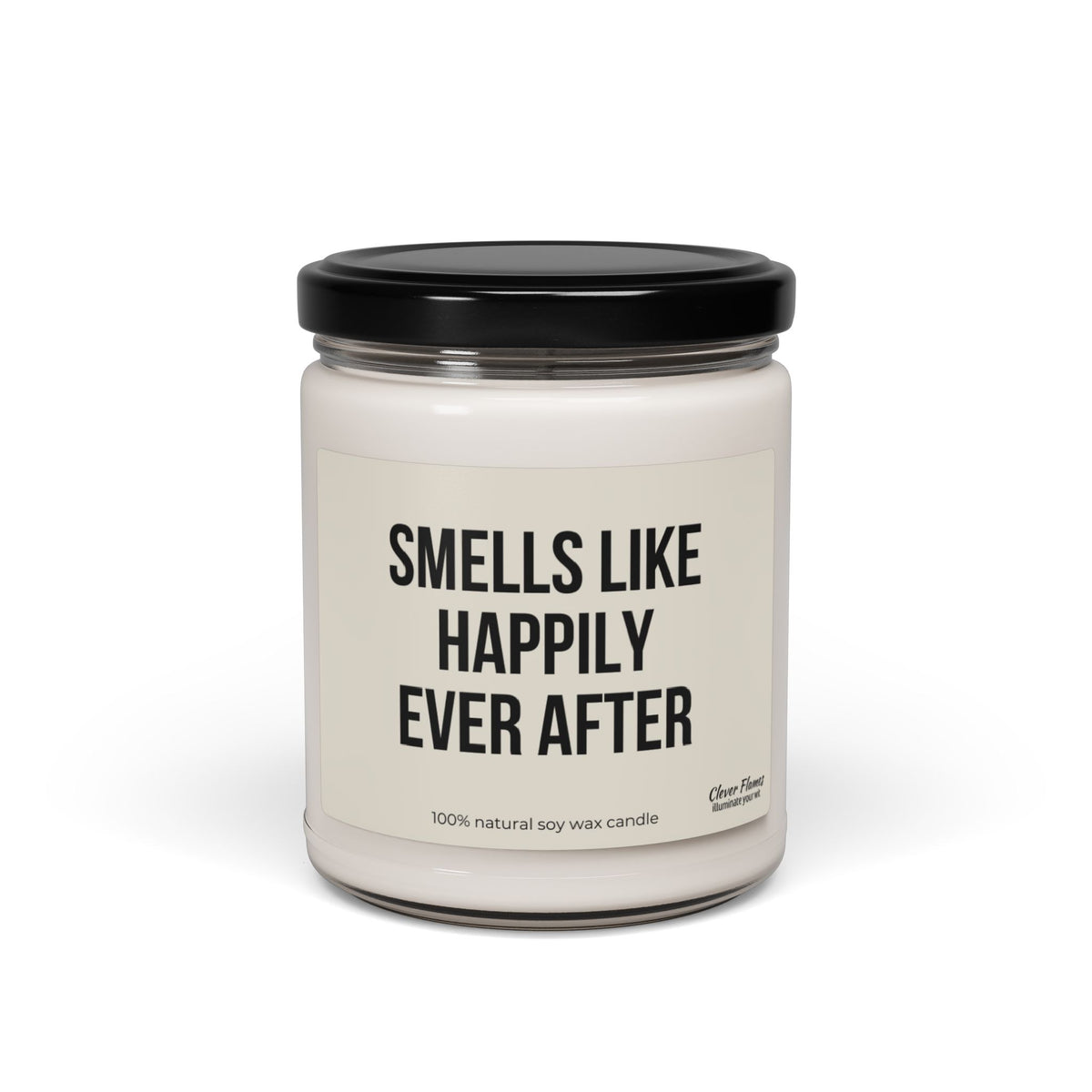 A white, scented candle made from 100% natural soy wax comes in a glass jar with a black lid, labeled "Smells Like Happily Ever After." This elegant Wedding candle is the perfect choice for an exquisite wedding favor or a delightful bridal shower gift.