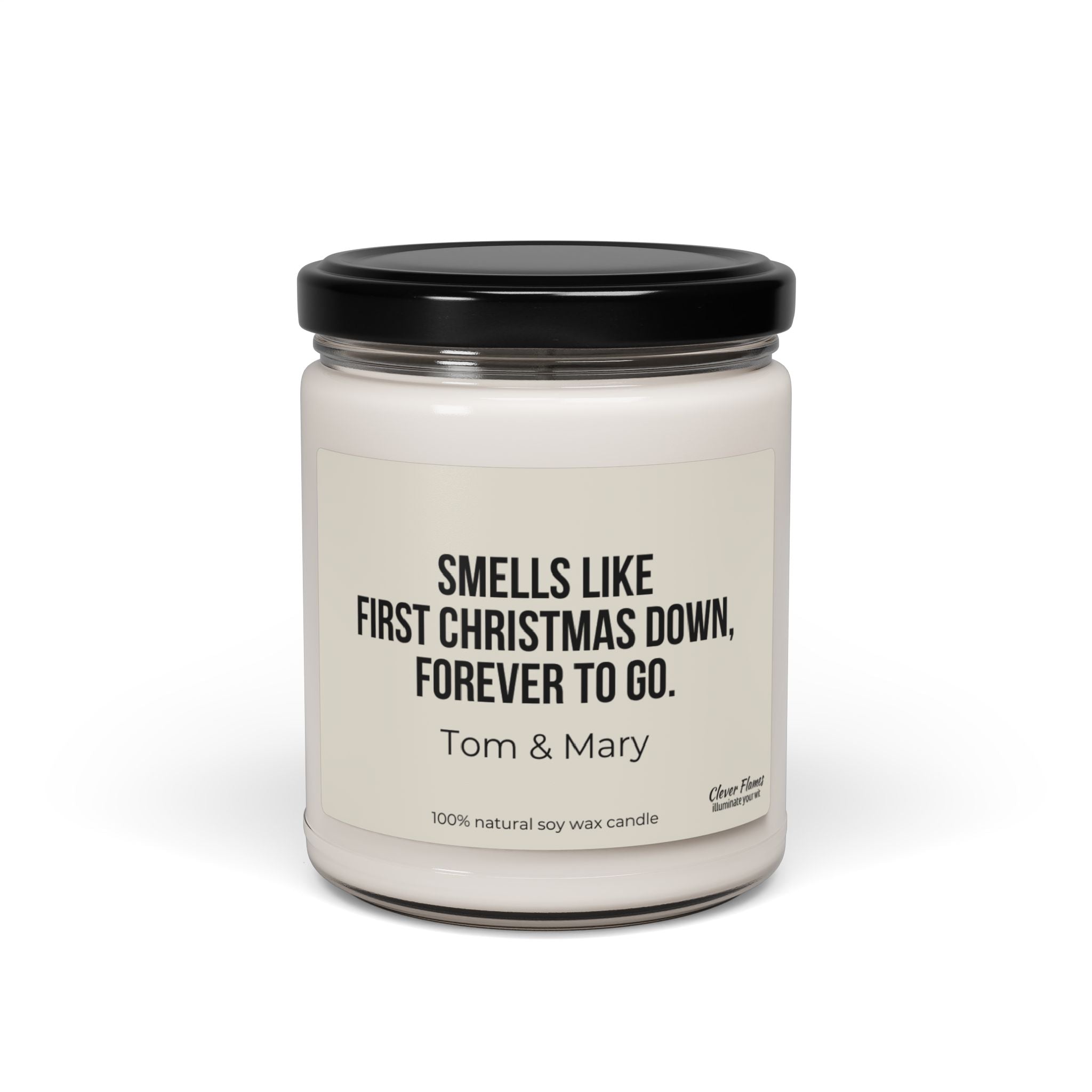 This candle from Printify, named "First Married Christmas Personalized Candle Engagement Gift for Mr. and Mrs. Newlywed," features white wax in a glass jar with a black lid. The label says, "Smells like first Christmas down, forever to go." Made from 100% natural soy wax, this scented candle makes the perfect personalized gift for any occasion.