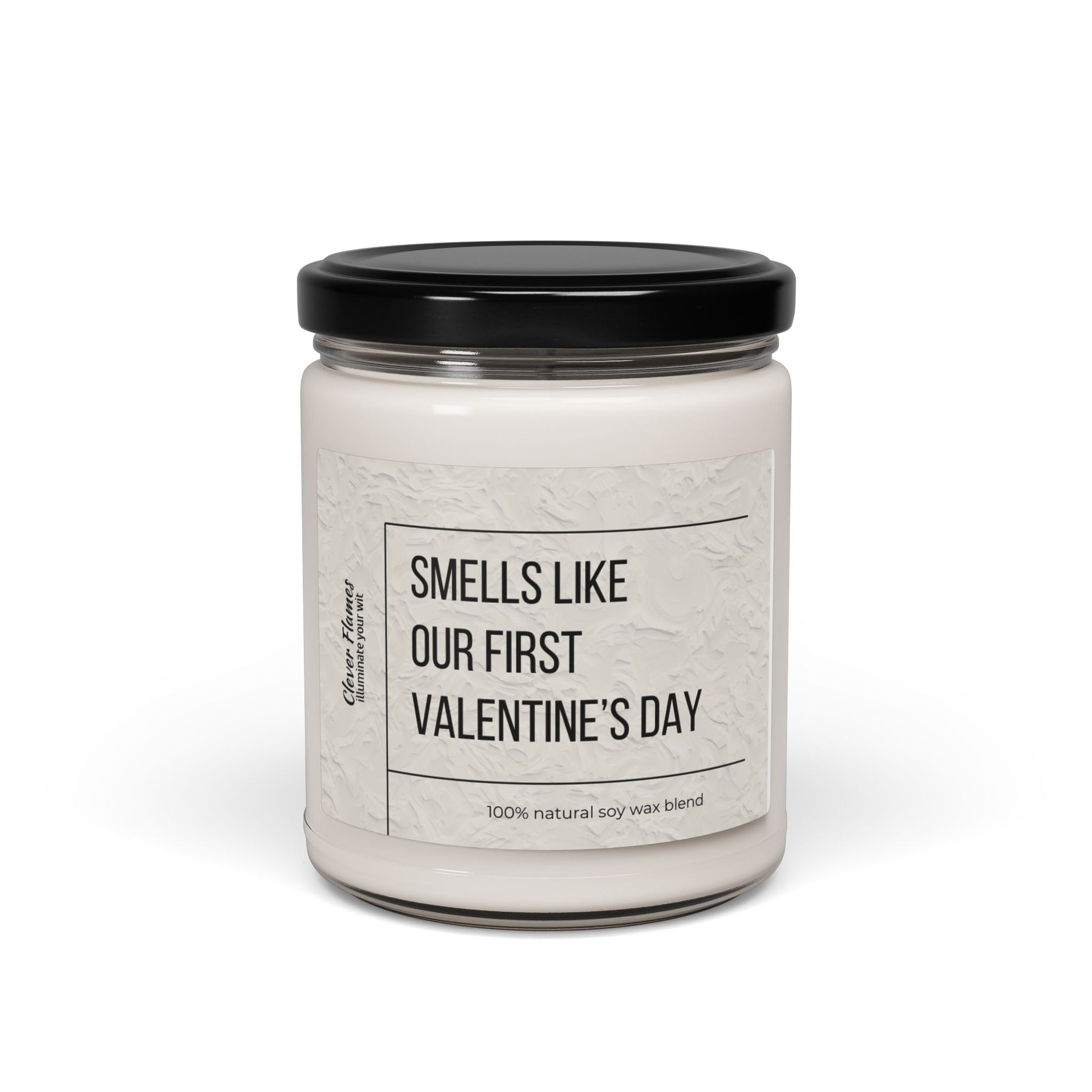 The Printify Smells Like Our First Valentines Day personalized romantic candle features a white soy wax blend in a glass jar with a black lid. Its elegant design and plain white background make it an ideal custom couples gift.