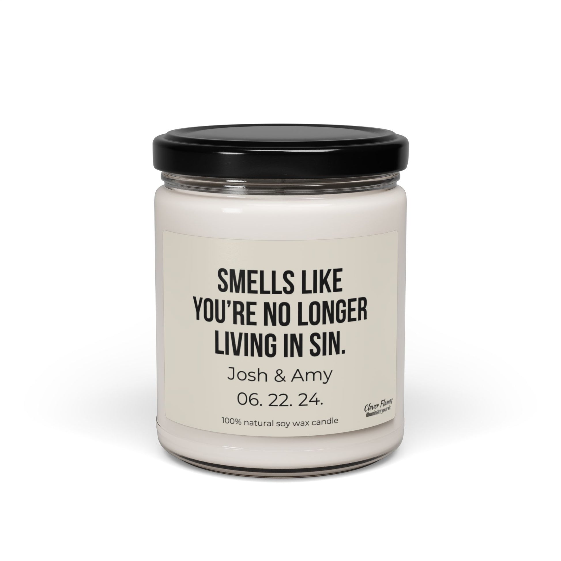 This white soy candle comes in a jar with a black lid and features the text "Smells like you’re no longer living in sin." Ideal for an engagement gift, it highlights the names Josh & Amy along with their date 06.22.24 and is made from 100% natural soy wax. The product is named "No Longer Living In Sin Soy Candle Custom Wedding Gift Funny Personalized Anniversary For Husband Engagement Date for Couple" by the brand Wedding.