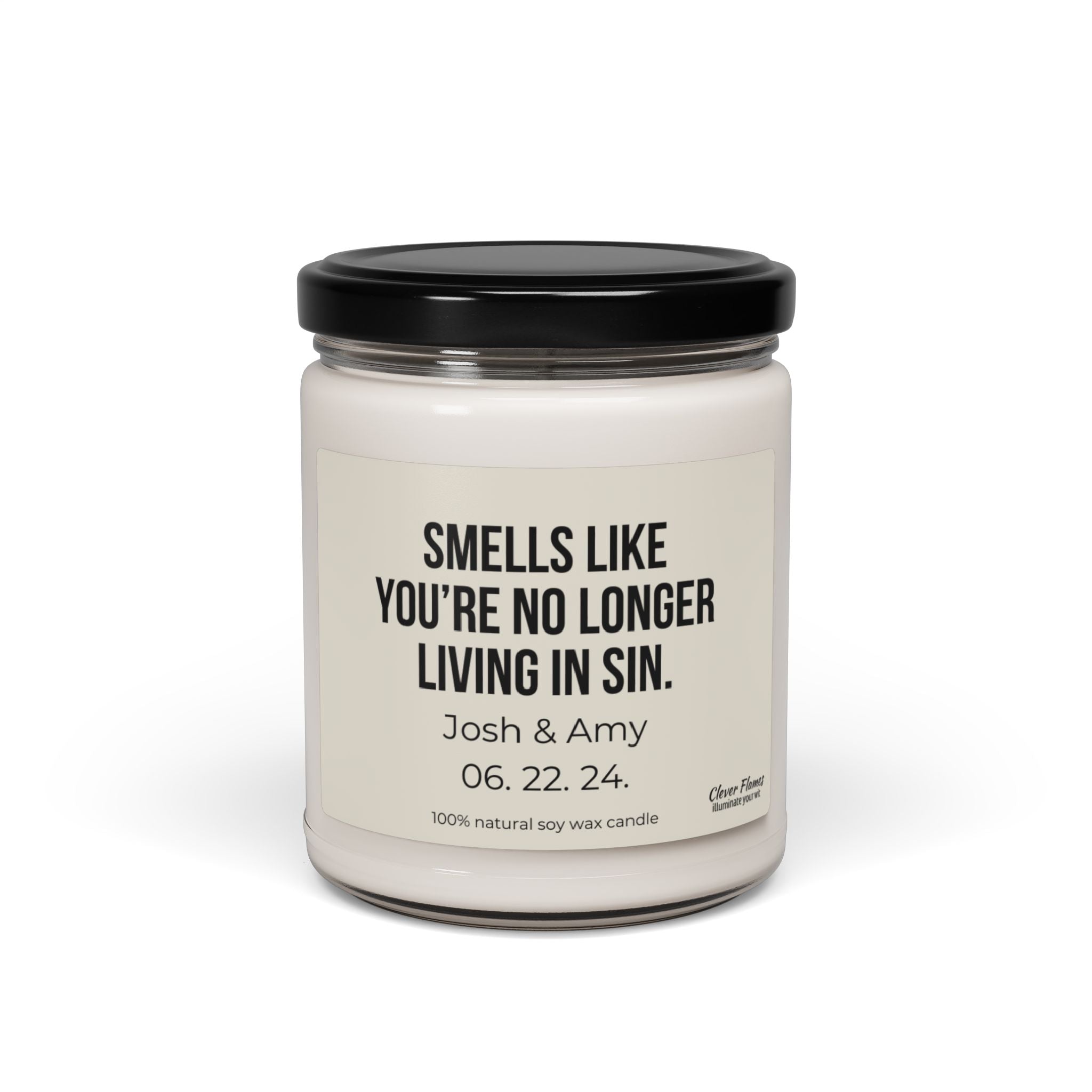 This white soy candle comes in a jar with a black lid and features the text "Smells like you’re no longer living in sin." Ideal for an engagement gift, it highlights the names Josh & Amy along with their date 06.22.24 and is made from 100% natural soy wax. The product is named "No Longer Living In Sin Soy Candle Custom Wedding Gift Funny Personalized Anniversary For Husband Engagement Date for Couple" by the brand Wedding.