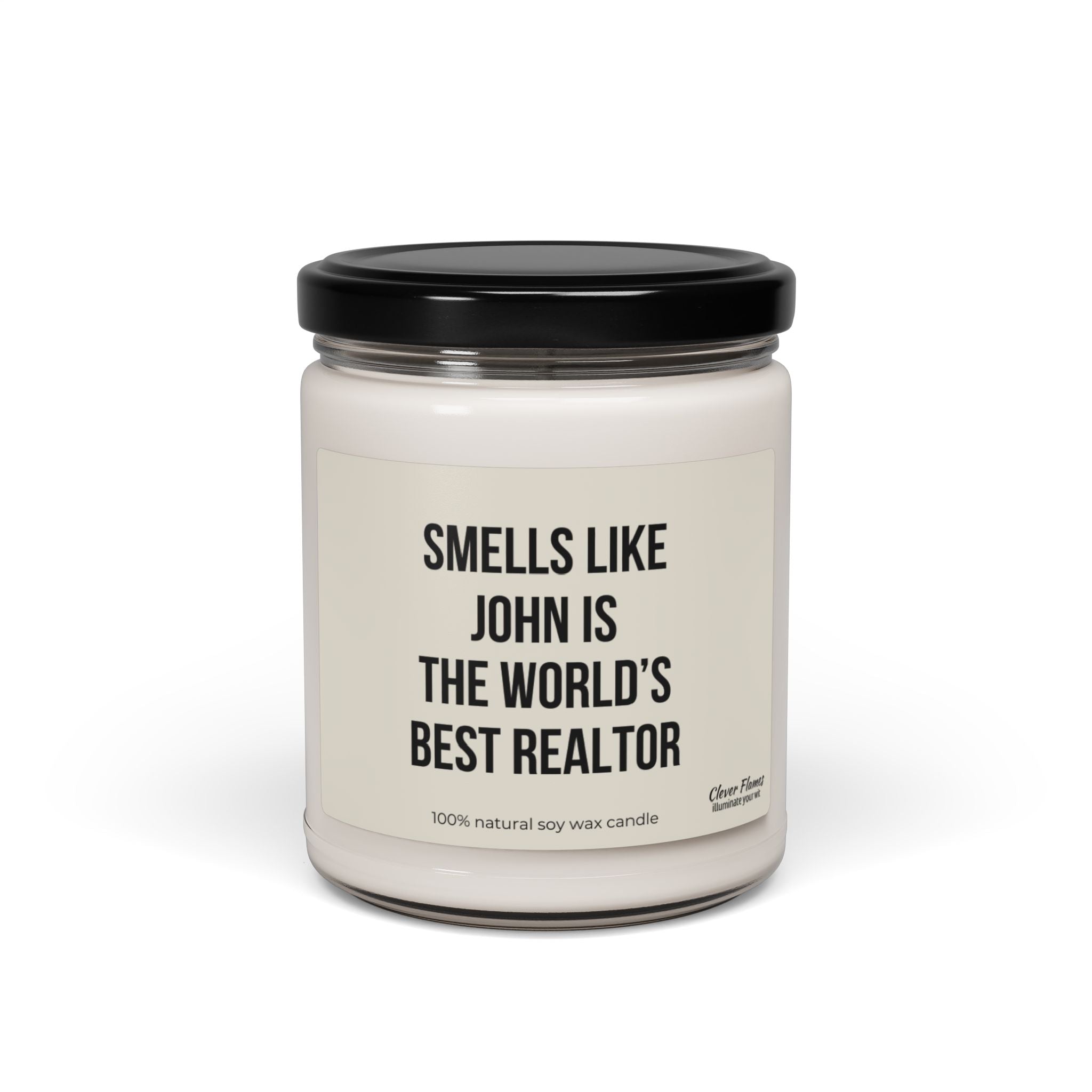 A white candle housed in a glass jar with a black lid features the label, "SMELLS LIKE JOHN IS THE WORLD'S BEST REALTOR." Created by Printify, this personalized candle is made from 100% natural soy wax and serves as an ideal real estate gift.