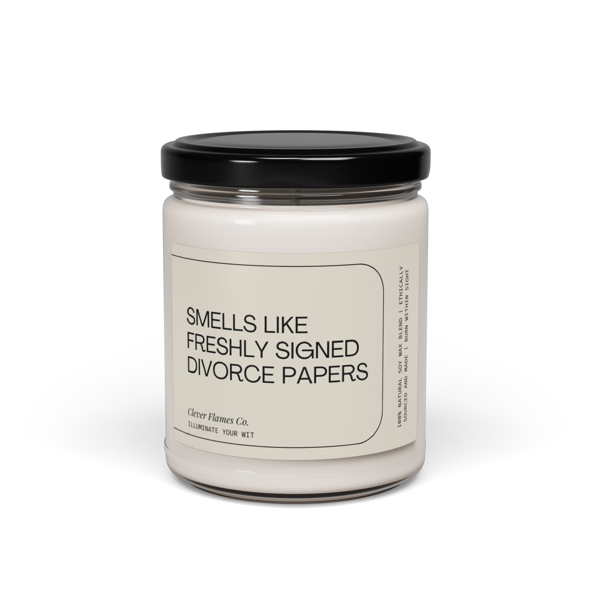 A candle jar made of glass and topped with a black lid, labeled Smells Like Freshly Signed Divorce Papers, is crafted from a natural soy wax blend. It's the perfect humorous gift for someone going through a divorce. The label proudly displays the brand Printify.