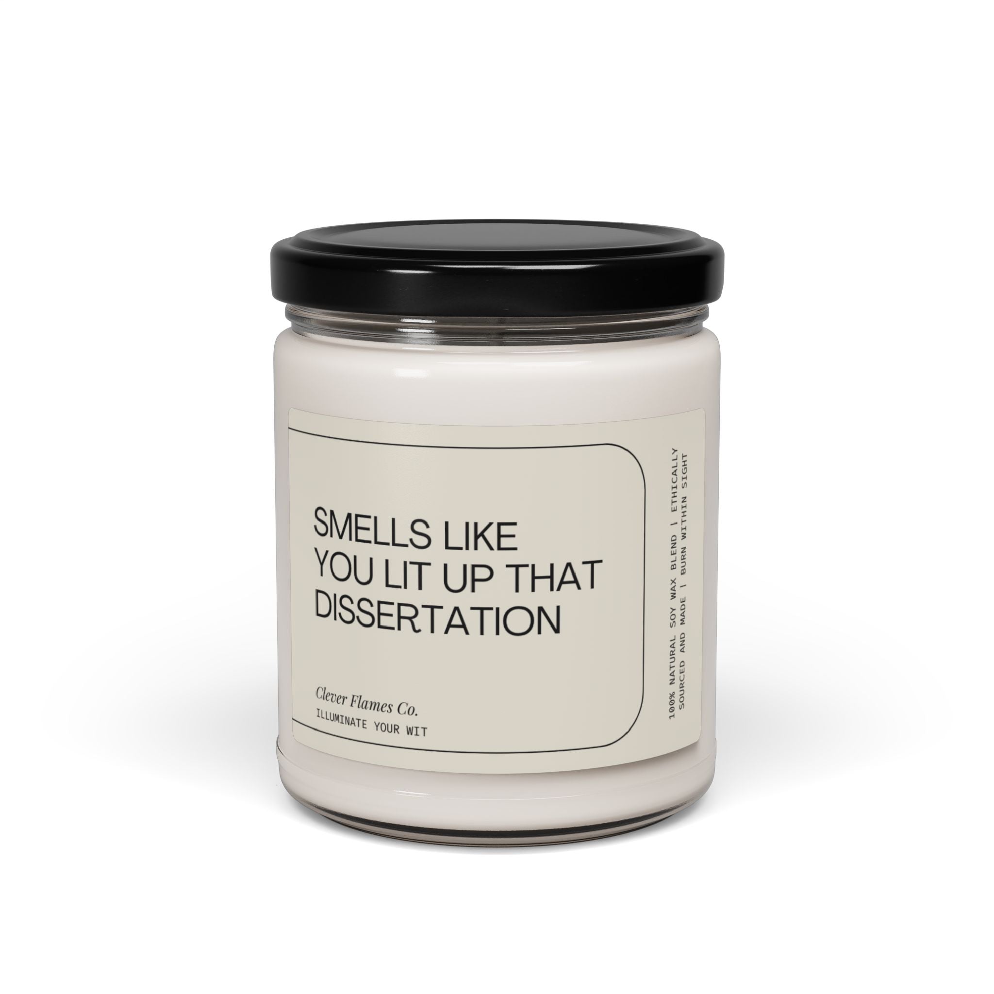 A white candle with a black lid, labeled "You Lit Up that Dissertation," from Printify, makes for a perfect PhD graduation gift. It reads "Smells like you lit up that dissertation" and features phrases like "Illuminate your wit," celebrating achievements with every scented flicker.