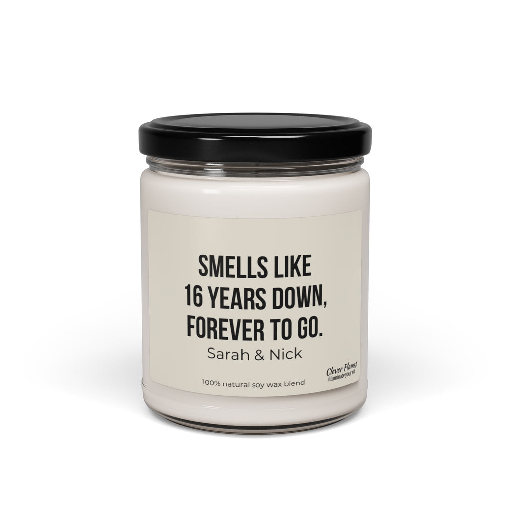 Introducing the perfect personalized gift to celebrate enduring love: the 16th Anniversary Candle by Wedding. This custom candle comes in a glass jar with a black lid, featuring a label that reads "SMELLS LIKE 16 YEARS DOWN, FOREVER TO GO. Sarah & Nick." Crafted from a 100% natural soy wax blend, it's an ideal way to commemorate your Wax Anniversary.