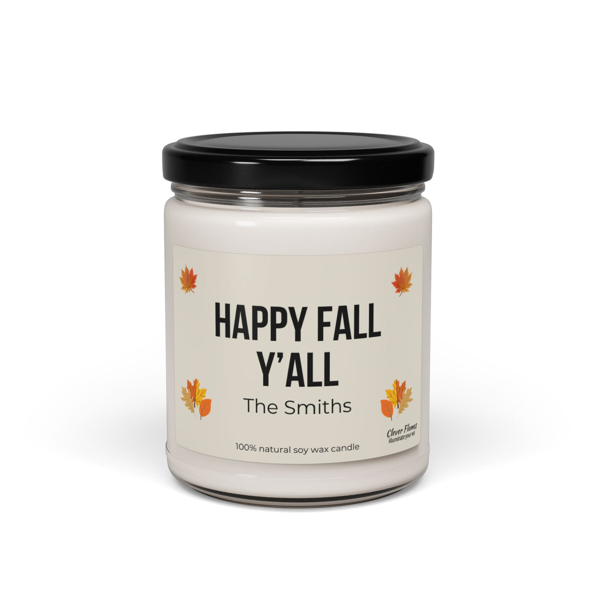 This scented soy candle from Printify, featuring a glass jar with a black lid, is labeled "Personalized Happy Fall Yall." Adorned with autumn leaves and customized with "The Smiths," it's perfect for fall decor. Made from 100% natural soy wax, it infuses your space with cozy autumn vibes.