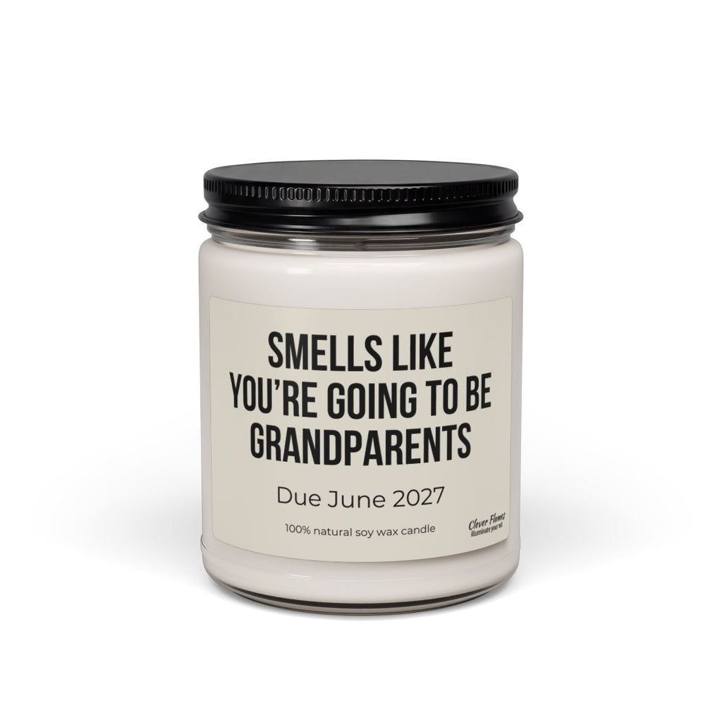 Introducing the “You’re Going to Be Grandparents – Personalized Pregnancy Announcement Candle | 9oz” by Printify: A white candle jar with a sleek black lid. The label reads, “Smells like you’re going to be grandparents. Due June 2027.” Made from 100% natural soy wax, this personalized candle is the perfect way to share your exciting news—an adorable grandparent gift and memorable pregnancy announcement they’ll cherish.