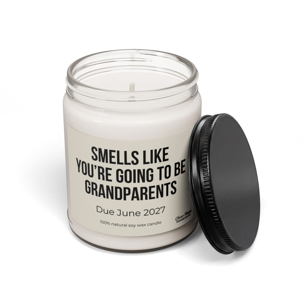 Introducing the “You’re Going to Be Grandparents – Personalized Pregnancy Announcement Candle” by Printify. This 9oz white soy candle comes in a glass jar topped with a black lid and features a label that reads, “SMELLS LIKE YOU’RE GOING TO BE GRANDPARENTS. Due June 2027.” It’s the perfect grandparent gift and a thoughtful way to reveal your baby news to loved ones.