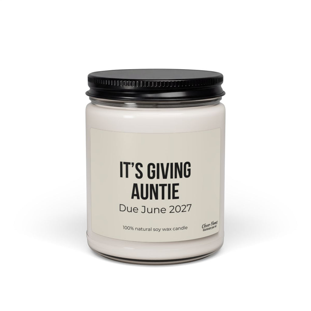 Introducing the Personalized Auntie Baby Announcement Candle – Pregnancy Reveal Gift for Aunt to Be | 9oz by Printify. This elegant white soy wax candle jar features a sleek black lid and a label that reads “ITS GIVING AUNTIE, Due June 2027, 100% natural soy wax candle.” Perfect as a unique pregnancy announcement or baby reveal gift, this personalized candle is sure to delight your loved ones and make your special news unforgettable.