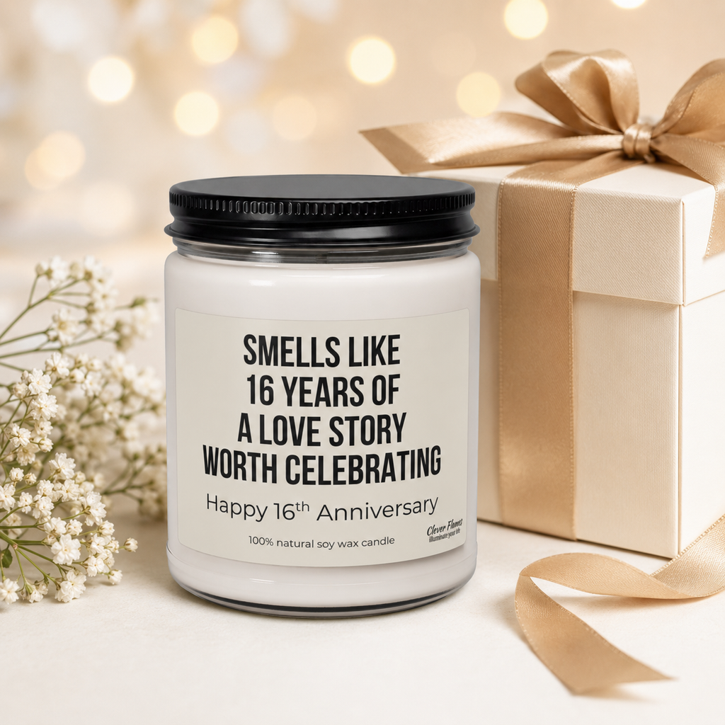 A Printify 16th Anniversary Candle—Wax Anniversary Gift for Parents or Couple, celebrating 16 years married—rests beside a gold-wrapped gift box, white flowers, and gold ribbon against a softly glowing background, making an elegant 16th wedding anniversary gift that’s perfect for making your special day unforgettable.