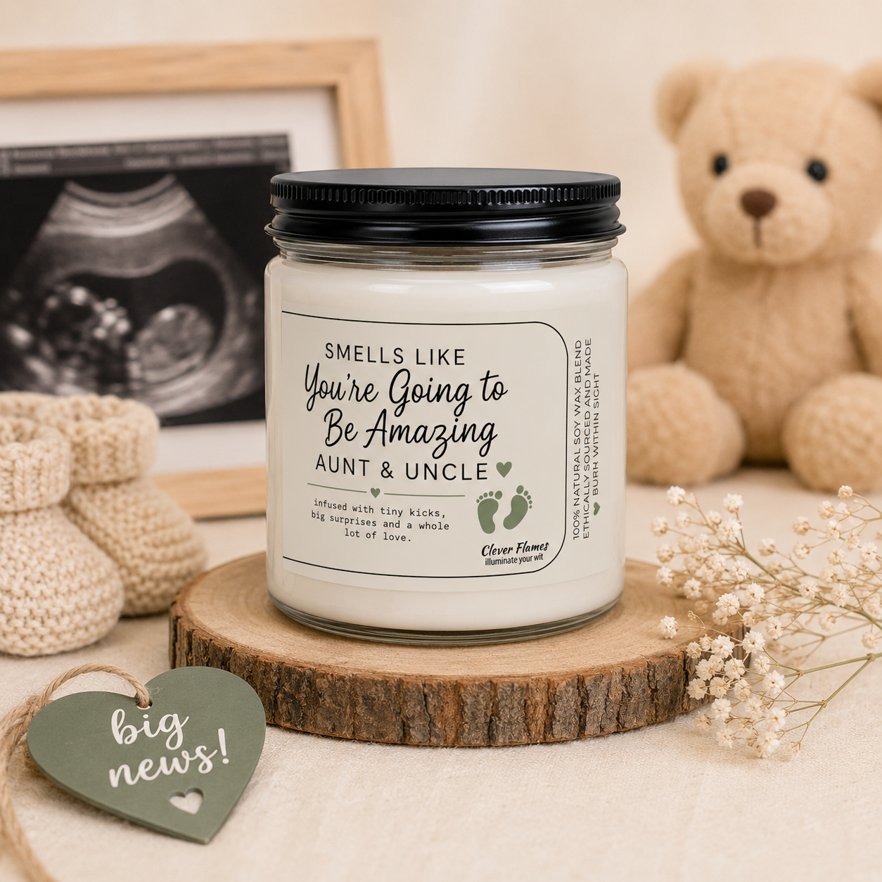 A Printify Pregnancy Announcement for Aunt & Uncle Candle, labeled “You’re Going to Be Amazing Aunt and Uncle,” rests on a wooden coaster amidst a framed ultrasound, baby booties, a teddy bear, white flowers, and a heart-shaped sign that reads “big news!” This charming candle makes a perfect baby reveal gift and is a thoughtful way to announce your pregnancy to future aunt and uncle.
