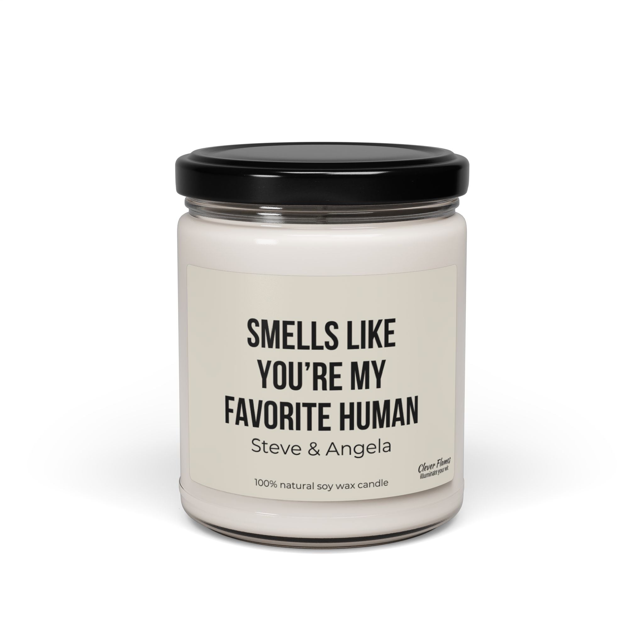 A white soy wax scented candle housed in a clear jar with a black lid features the label "Smells like you're my favorite human" by Printify, making it an ideal personalized anniversary gift.