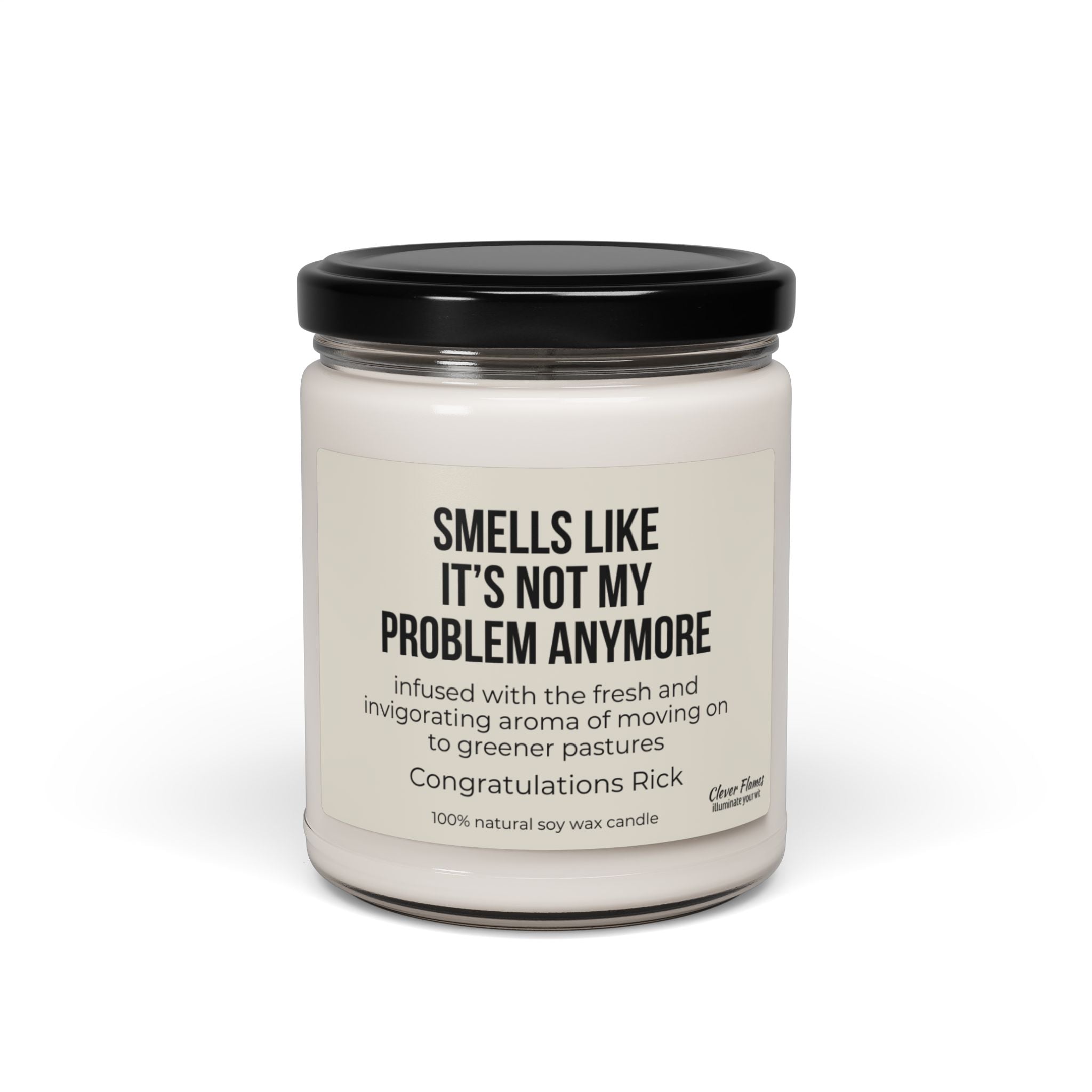 A white soy candle by Printify comes in a glass jar with a black lid, ideal as a humorous farewell gift. The label reads "SMELLS LIKE IT'S NOT MY PROBLEM ANYMORE" and includes a message about moving forward. It features a personalized "Congratulations Rick" note for an extra special touch.