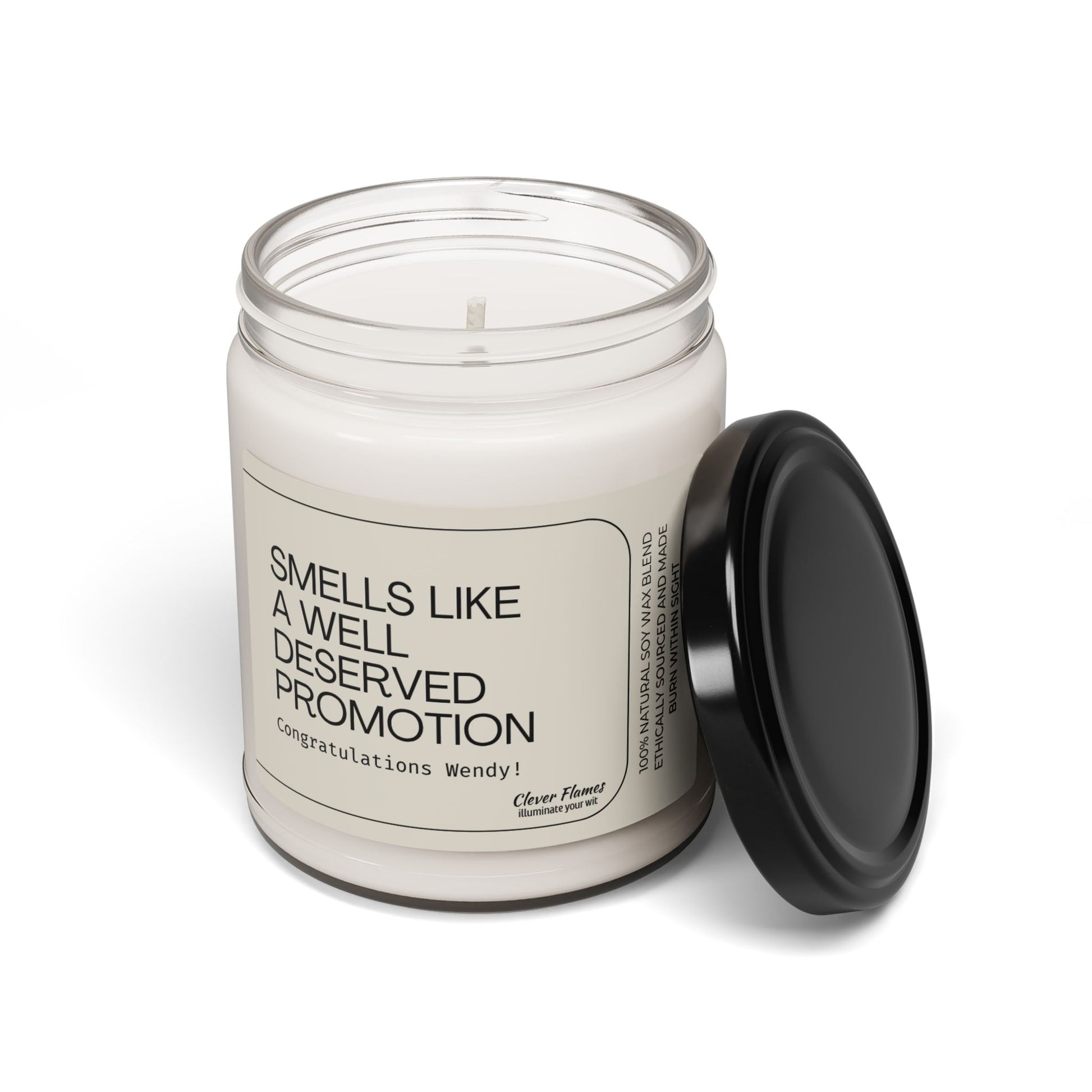 The Smells Like a Well Deserved Promotion personalized candle by Printify, a white jar candle with black lid and congratulatory label, is the perfect office gift or promotion present. Lid displayed next to jar on white background.