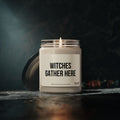 The Soy Candle, Halloween Witch Gathering Theme by Printify glows in a glass jar with a black lid, filling your space with a Cinnamon Vanilla scent—ideal for adding spooky charm to any room.