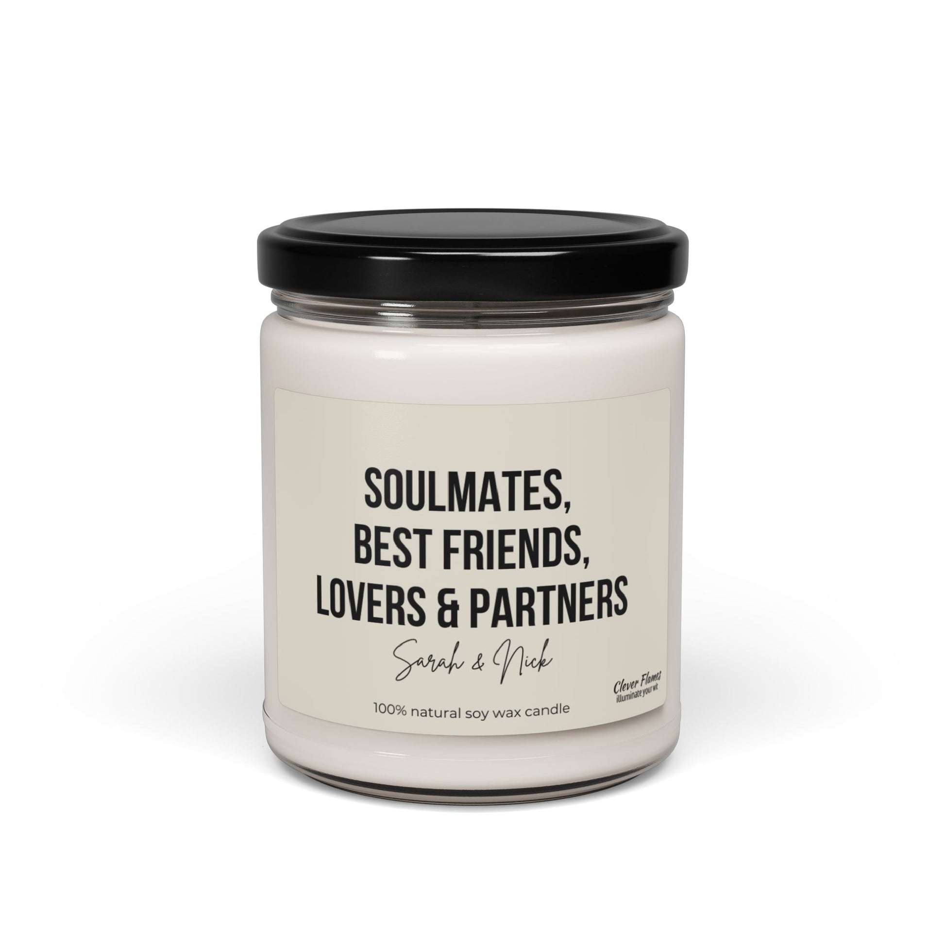 A custom soy wax candle housed in a glass jar with a black lid, featuring the label "Soulmates, Best Friends, Lovers & Partners - Sarah & Nick." This makes an ideal Anniversary Candle Gift, created by Wedding, for celebrating cherished moments together.