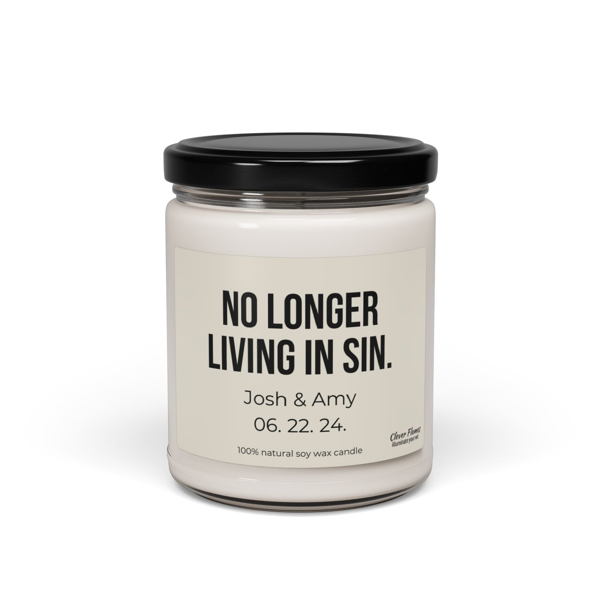 This custom soy candle from Wedding, featuring the humorous "No Longer Living In Sin" label, is an ideal anniversary gift. Personalized with "Josh & Amy 06.22.24," it celebrates their special day in a glass jar topped with a black lid and handcrafted from 100% natural soy wax for elegant charm.