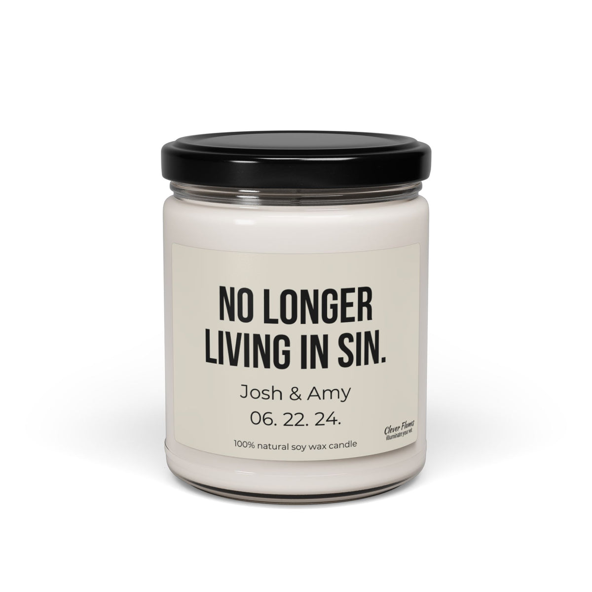 This custom soy candle from Wedding, featuring the humorous "No Longer Living In Sin" label, is an ideal anniversary gift. Personalized with "Josh & Amy 06.22.24," it celebrates their special day in a glass jar topped with a black lid and handcrafted from 100% natural soy wax for elegant charm.