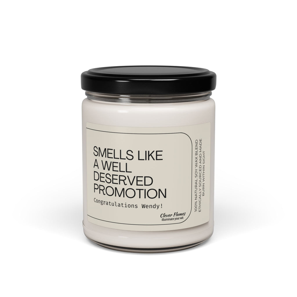The Smells Like a Well Deserved Promotion personalized soy wax candle by Printify features a white, clean-burning wax in a glass jar with a black lid. The custom label reads: Congratulations Wendy! Photographed on a white background.