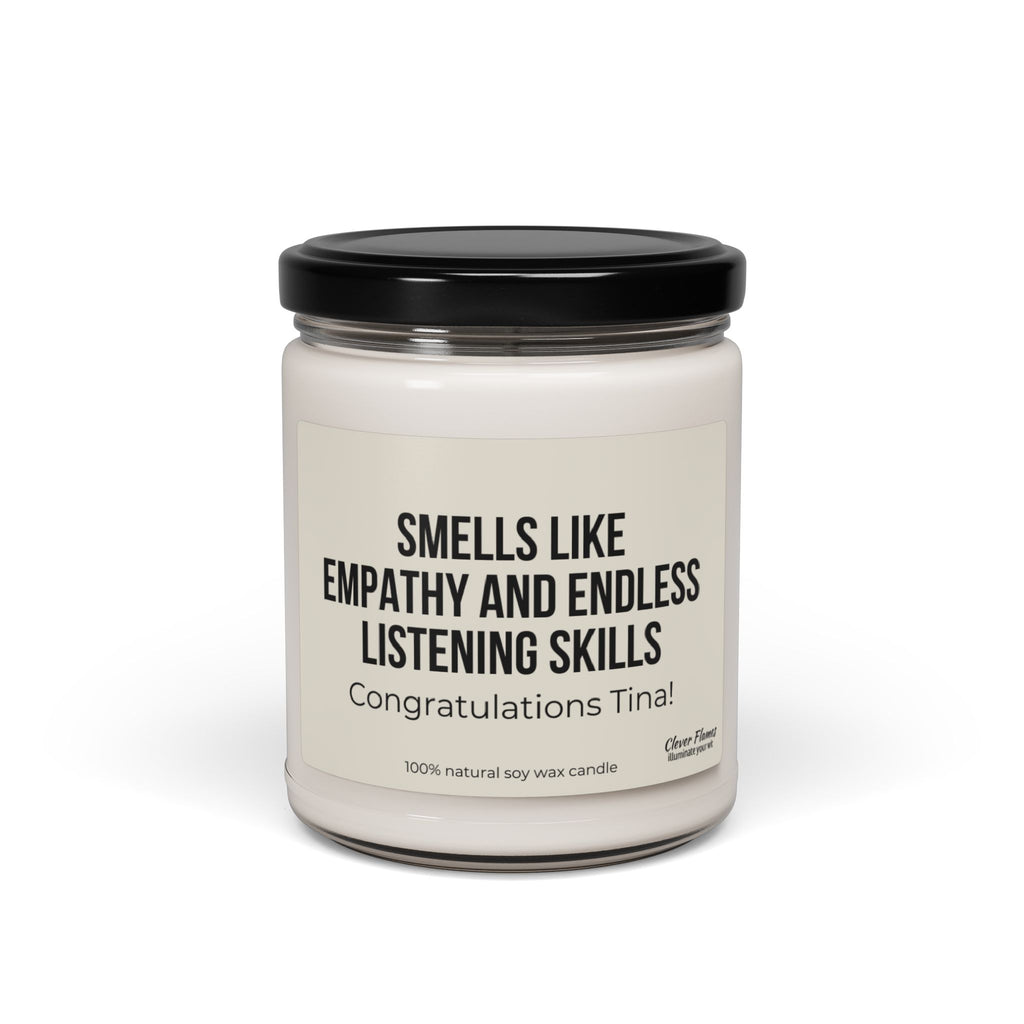 A Printify candle named "Gift For Counselor Gift for Counselor Appreciation Candle For Therapist Thank You Gift for Personalized Appreciation Gift for Therapist" features white soy wax in a clear glass jar with a black lid. The label reads: Smells like empathy and endless listening skills. Congratulations, Tina! This is the perfect personalized candle gift to celebrate compassionate souls.