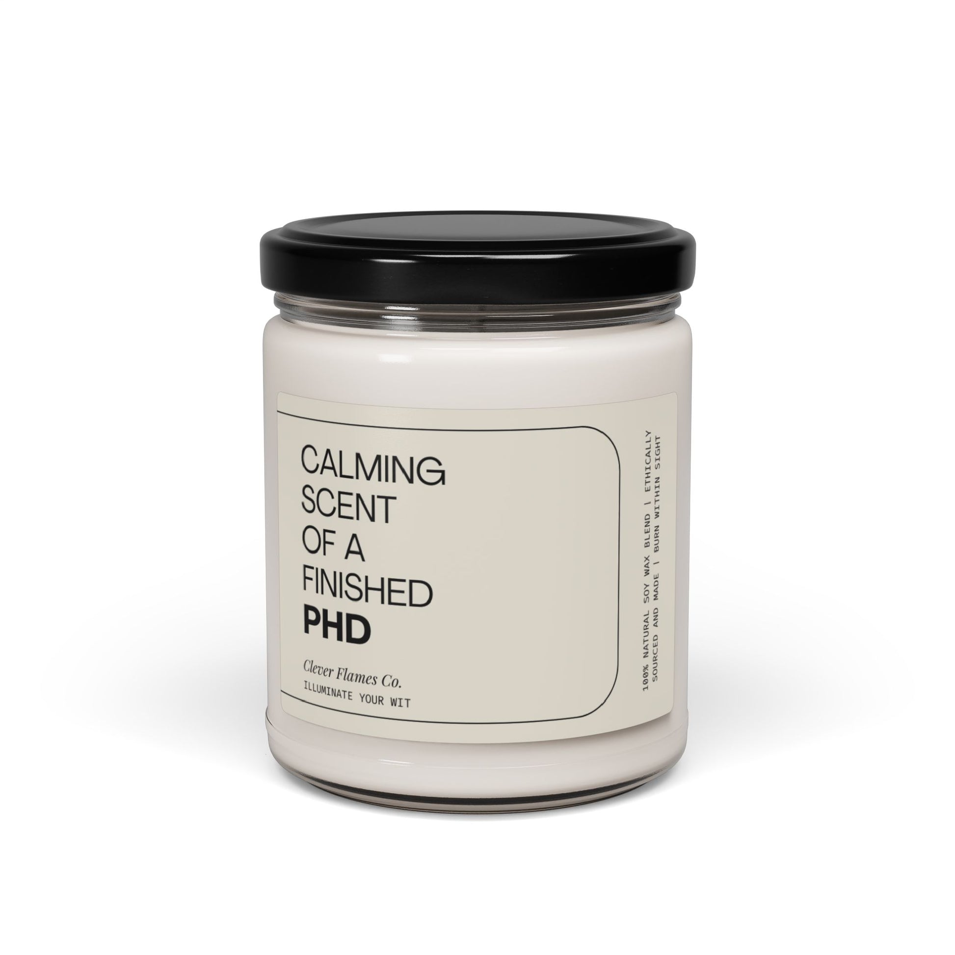 A glass candle jar with a black lid, labeled as "Finished PhD," serves as the perfect graduation gift, created by Printify to illuminate your wit.