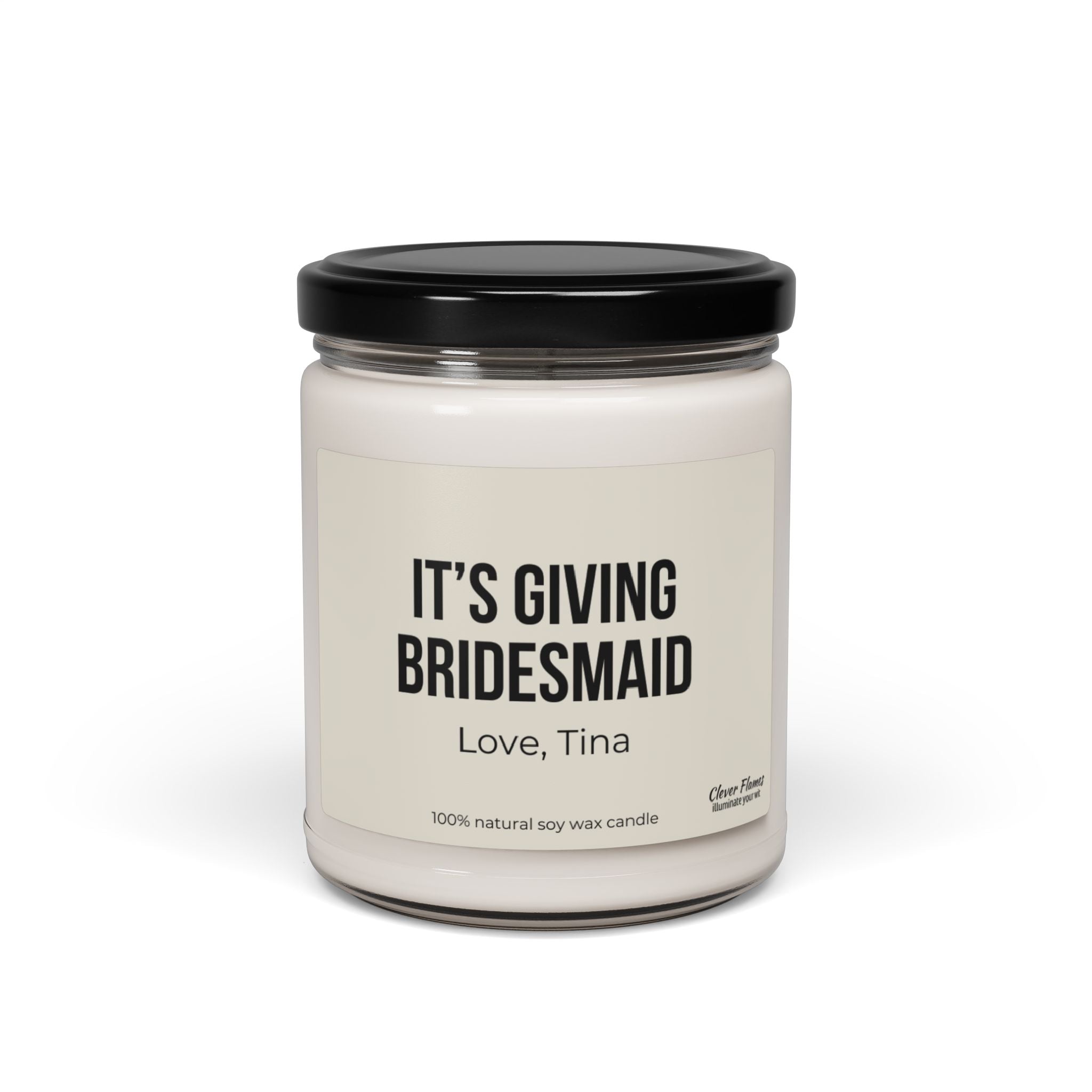 The Personalized It's Giving Bridesmaid Candle from Wedding features a white jar with a black lid, labeled ITS GIVING BRIDESMAID with Love, Tina underneath. Crafted from 100% natural soy wax, this custom candle makes an ideal personalized gift for bridesmaids.