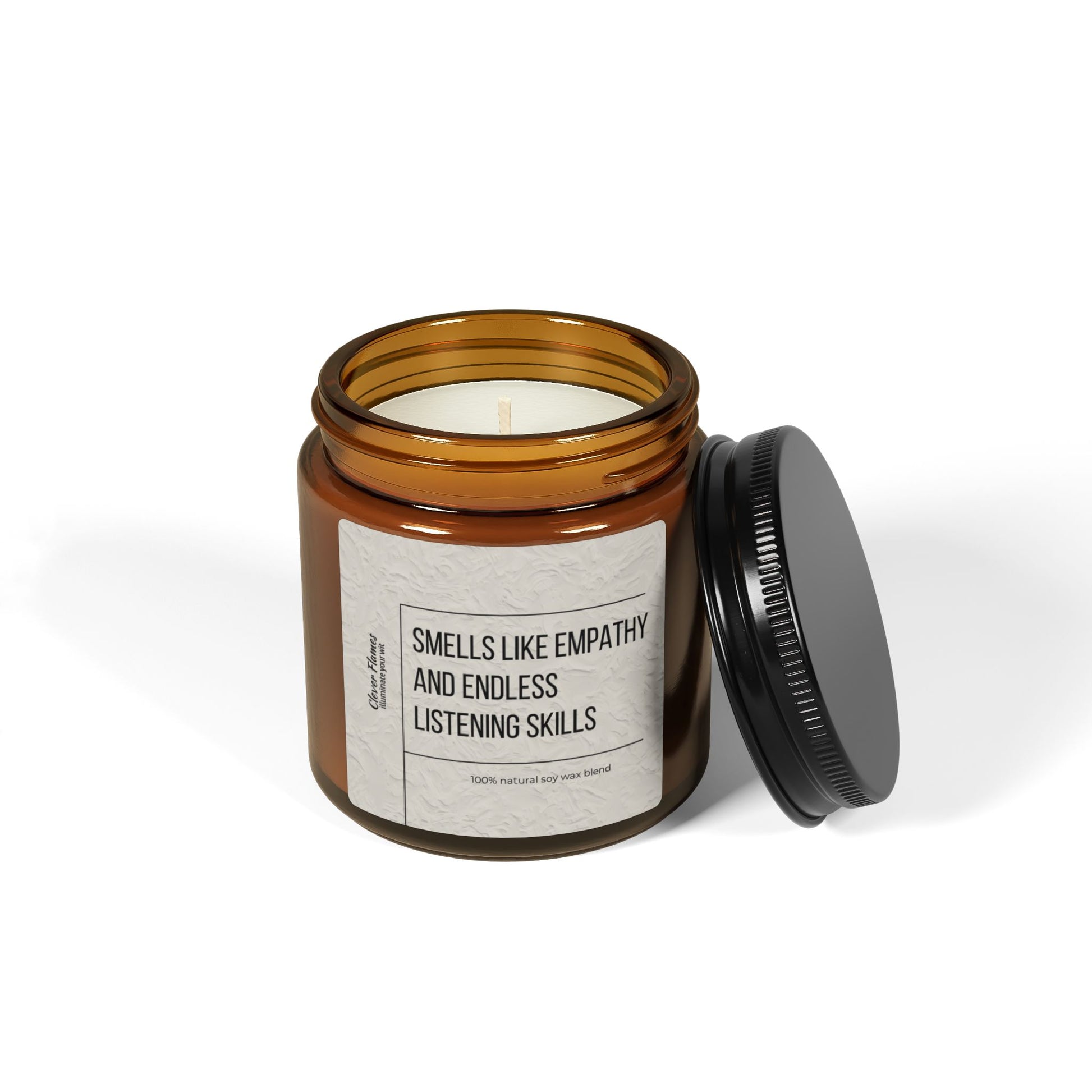 A brown glass soy candle jar from Printify, featuring a black screw-on lid placed beside it, displays the label "Counselor Candle - Smells Like Empathy & Endless Listening Skills." This white scented candle is perfect for creating a cozy Christmas ambiance, promising to fill your space with warmth and serenity. It's an ideal gift for therapists, social workers, and mental health heroes.