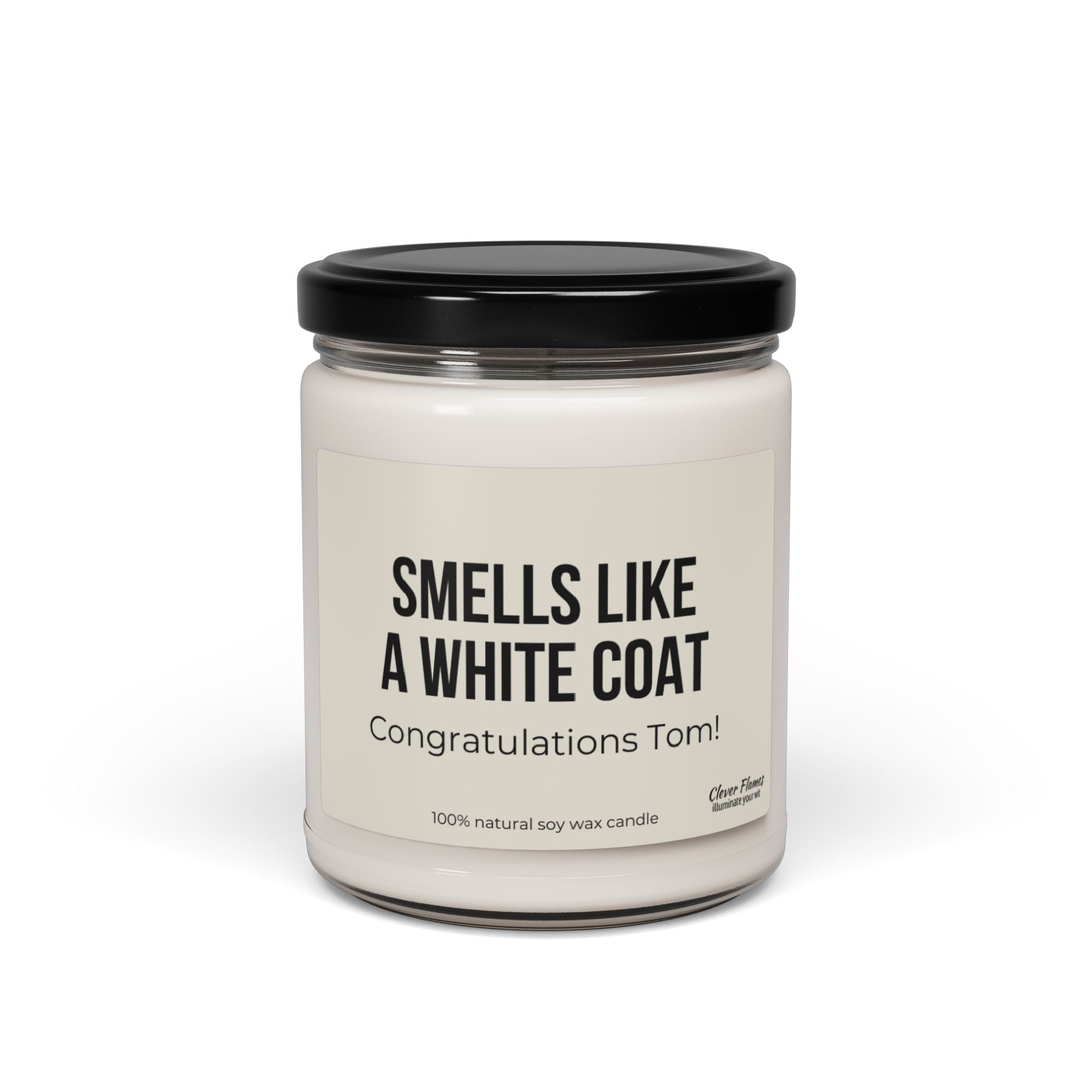 This personalized Smells Like A White Coat candle by Printify is an ideal gift for a medical student. It comes in a glass jar with a black lid and the label reads "SMELLS LIKE A WHITE COAT" with "Congratulations Tom!" underneath, celebrating his white coat ceremony. It's made with 100% natural soy wax, perfect for the doctor in training.