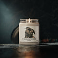 The My Humans Are Getting Married Personalized Pet Engagement Candle by Printify features a black dog with custom text, making it a thoughtful engagement gift. The lit white candle comes in a glass jar, with the lid beside it on a dark surface.
