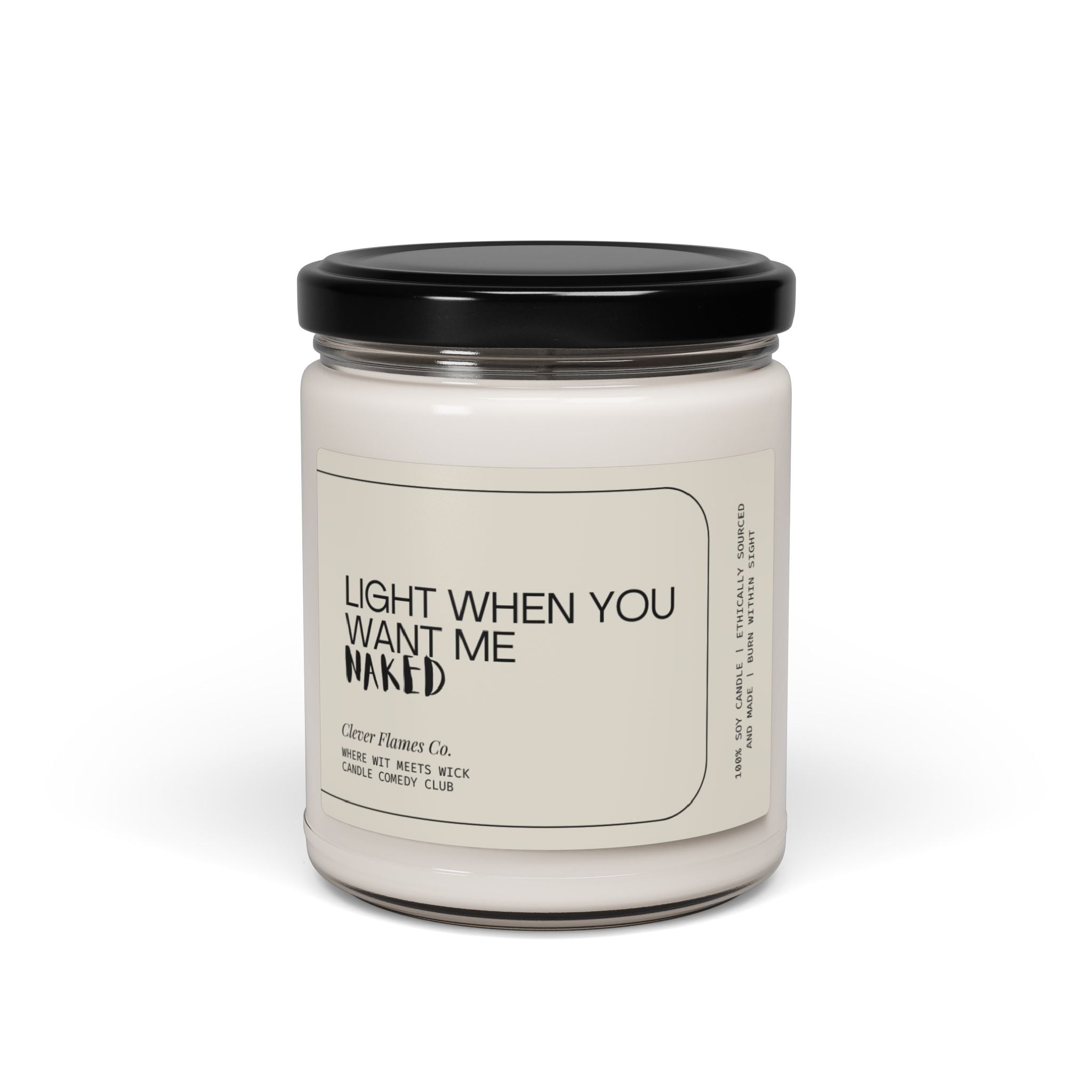 A white scented candle made from natural soy wax is encased in a clear glass jar with a black lid. The label, "LIGHT WHEN YOU WANT ME NAKED," adds a touch of humor and charm, courtesy of Printify. This makes an ideal Valentine's Day gift for those who appreciate wit and warmth.