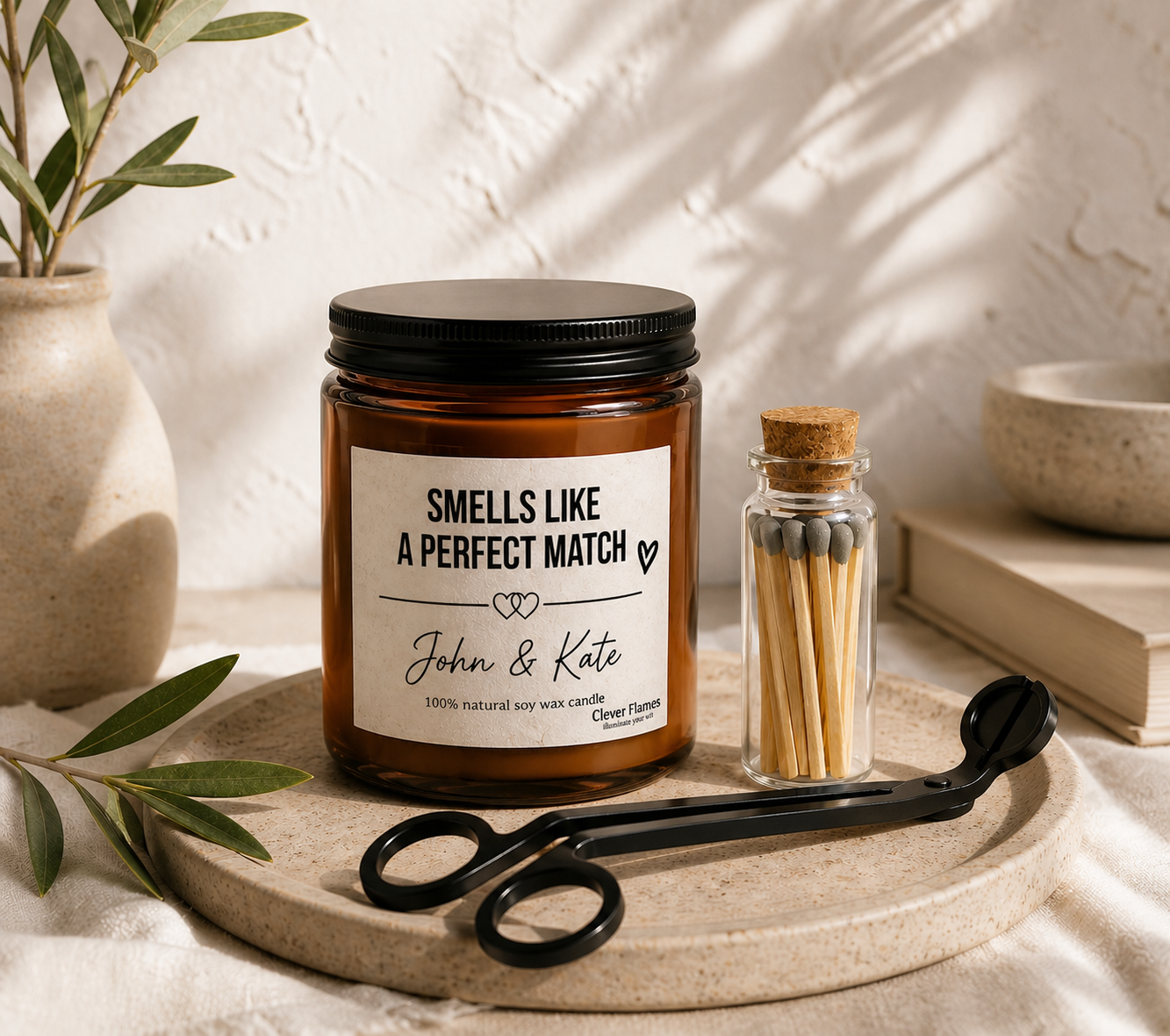 The Smells Like a Perfect Match Candle Set with Matches and Wick Trimmer by Printify features a personalized soy candle in a brown glass jar—an ideal gift, elegantly presented with neutral decor and olive branches.